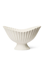White ceramic bowl with ribbed design on a white background