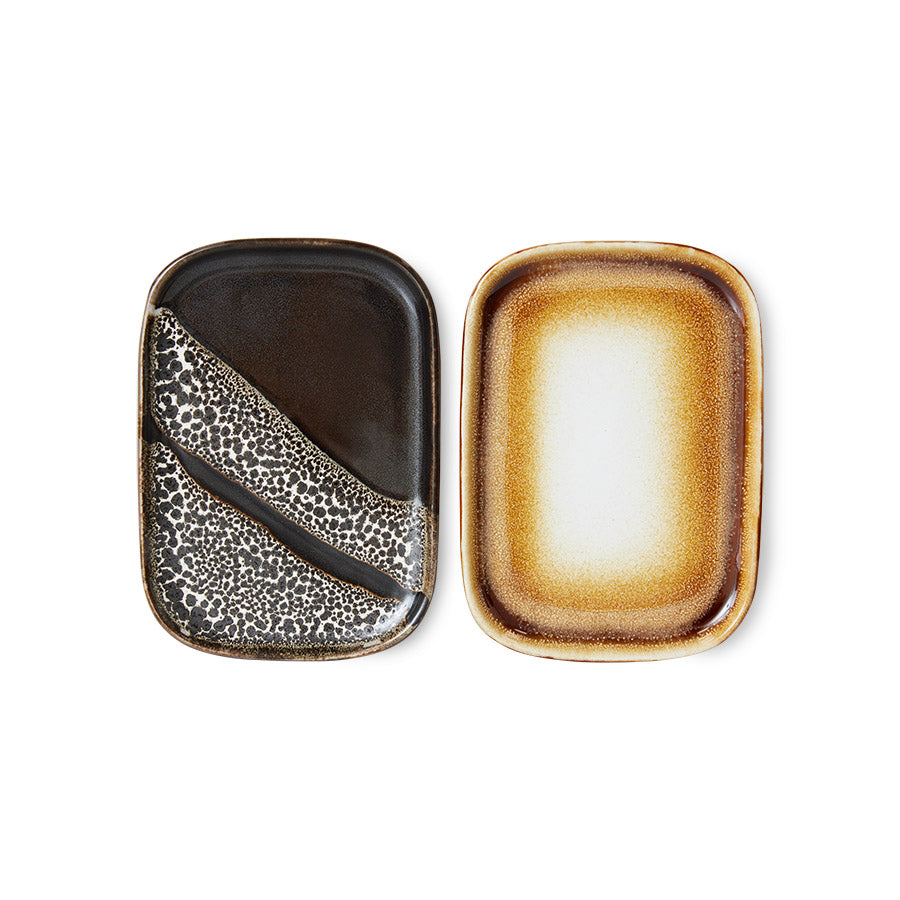 Two ceramic plates with textured surfaces on a white background