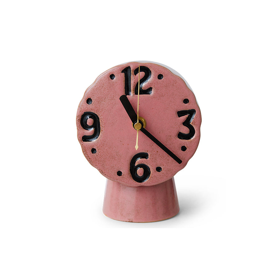 Pink retro clock with black numbers on a white background