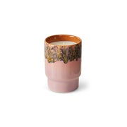 Ceramic candle with floral design on a white background