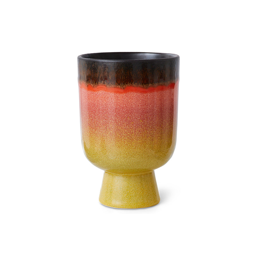 Ceramic plant pot with gradient color from black to yellow on a white background