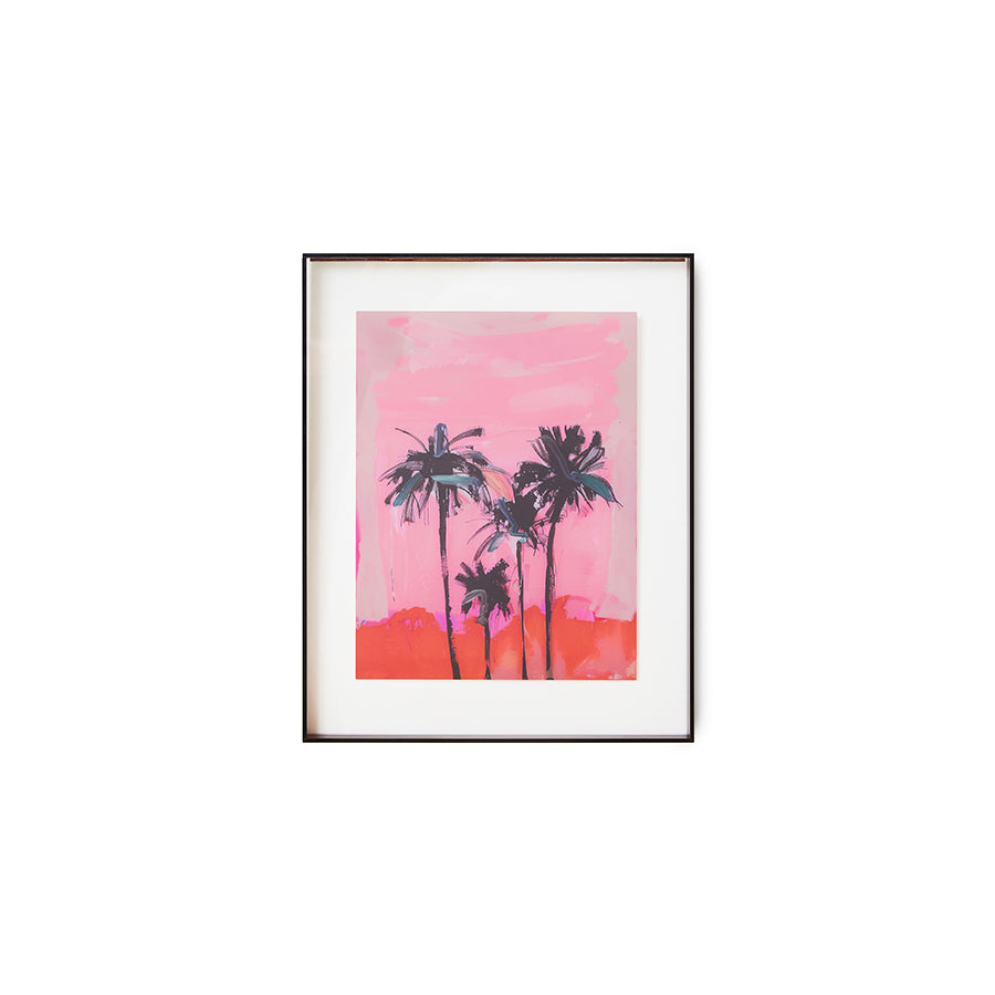 Framed artwork of palm trees against a pink sky on a white background