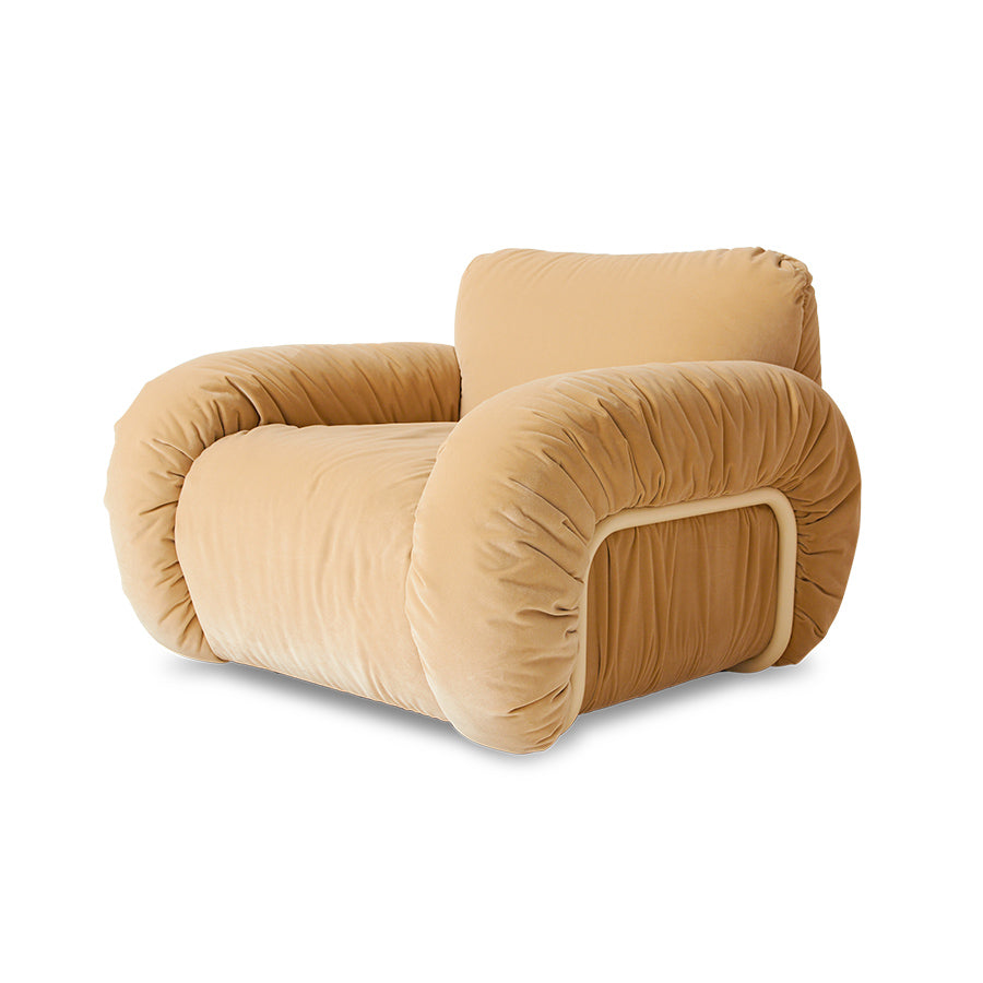 Beige plush armchair on a white background