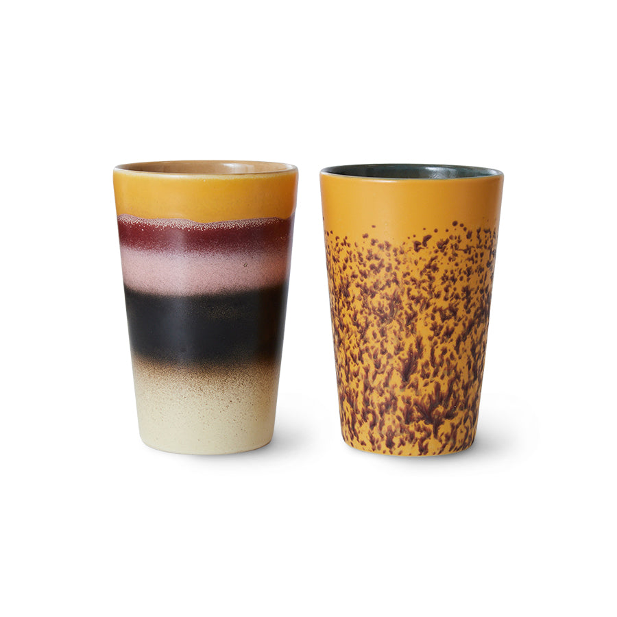 Two ceramic tumblers with gradient and speckled designs on a white background