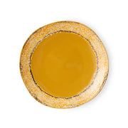 Round ceramic plate with a textured edge on a white background