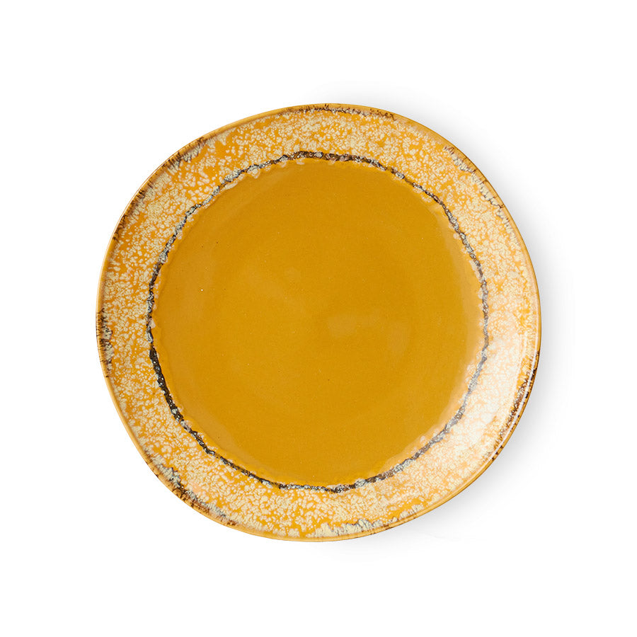 Round ceramic plate with a textured edge on a white background