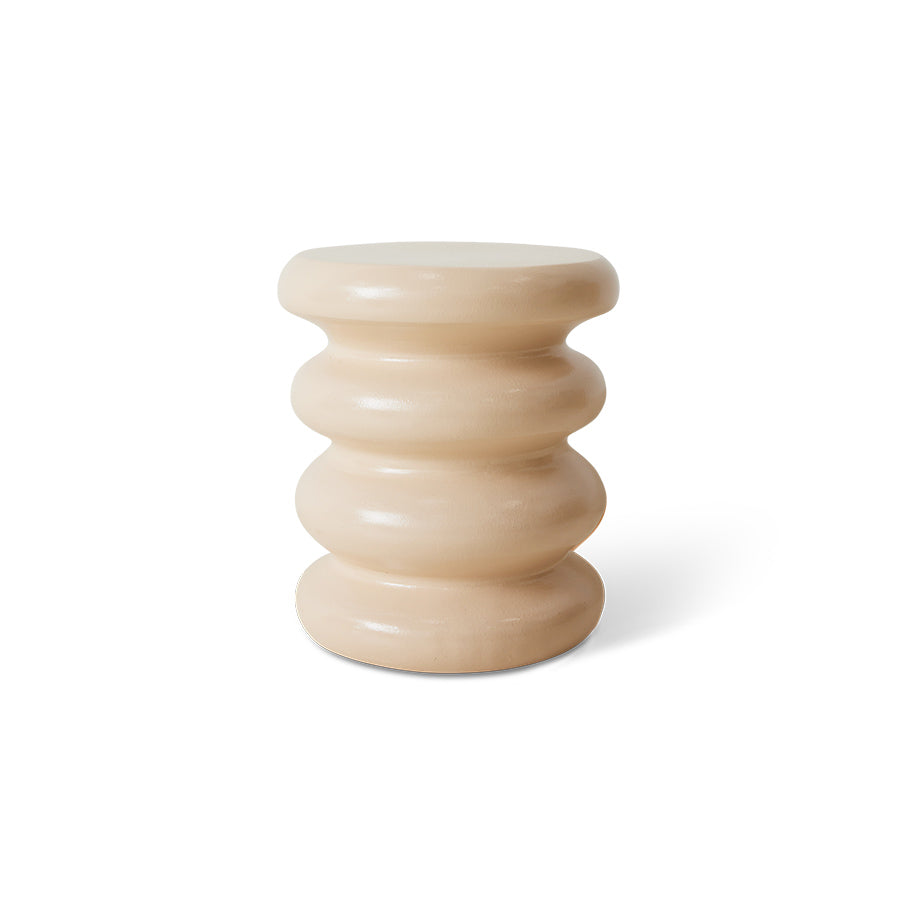 Beige cylindrical stool with stacked design on a white background
