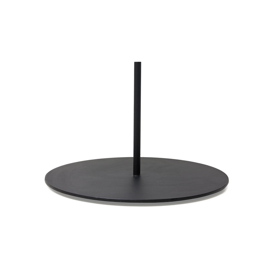 Black round base for sculpture with a central pole on a white background