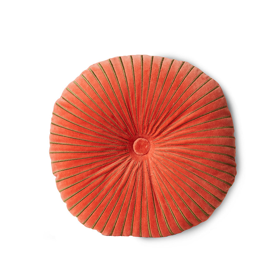 Round orange pillow with pleated texture on a white background