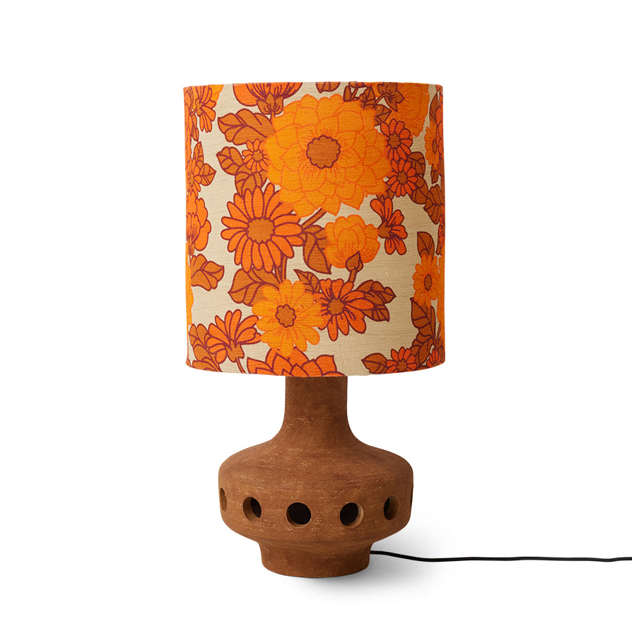 Table lamp with a floral-patterned orange and beige shade on a white background
