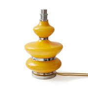 Yellow table lamp with silver accents on a white background