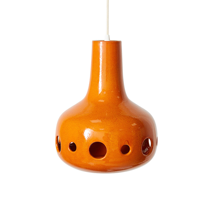 Orange ceramic hanging lamp with holes on a white background